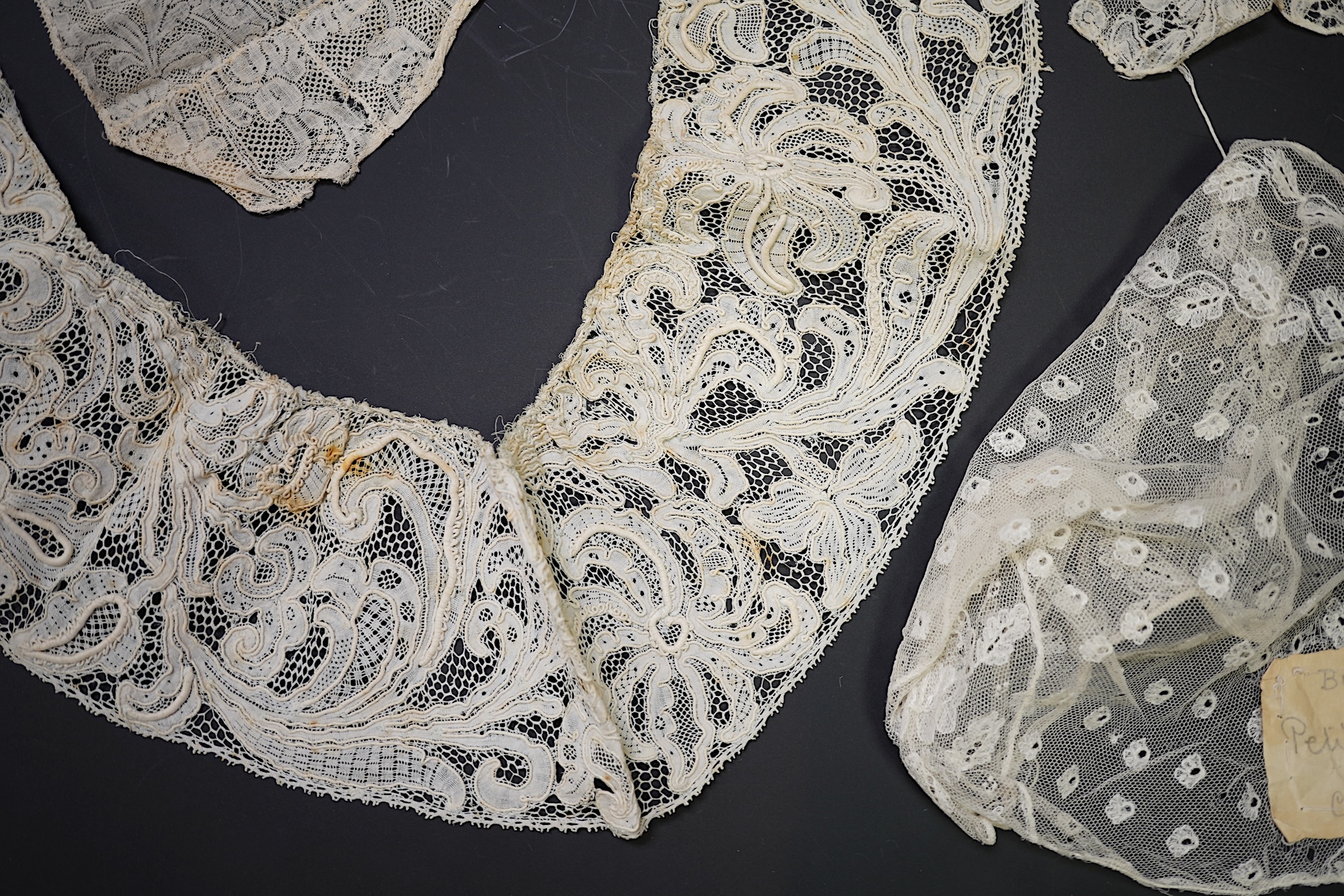 Various lengths of 18th and 19th century lace trimming and two needle run bonnets. Including a collar made from two rows of 18th century Valenciennes lace, a length Valenciennes lace, a shorter length of Pointe de Anglet